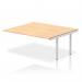 The photo shows a modern and sleek Dynamic Bench Desk with Add On Units and an extended B2B kit. The bench has a silver frame and a maple top, providing a stylish addition to any office space. The overall design is clean and functional, perfect for a professional work environment.