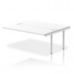 The photograph shows a modern, sleek Dynamic Bench Desk with Add On Units. The silver frame and white surface create a professional look, perfect for any office space.