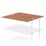 A photo of the dynamic bench desk add on units shows a sleek white frame with a rich walnut top, perfect for a modern office space. The bench desk allows for seamless collaboration and a streamlined work environment.