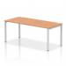 The picture shows a modern office space with a sleek silver-framed bench desk in the foreground. The desk has a glossy oak top and is part of a single row of dynamic bench desking. The overall look is clean, efficient, and professional.
