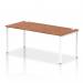This photo captures a sleek and modern bench desk with a white frame and a rich walnut top. The single row design creates a dynamic and functional workspace, perfect for any office setting.