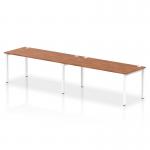 The dynamic bench desking impulse bench single row 2 person 1800 with a white frame creates a modern and sleek aesthetic in any office space. Paired with a warm walnut bench desk, this setup exudes elegance and functionality.