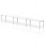 This photo features a sleek and modern office setup with a dynamic bench desking system. The silver frame adds a touch of sophistication and the white desk provides a clean and crisp look. This single row setup can comfortably accommodate 3 people, making it an ideal choice for collaborative work.