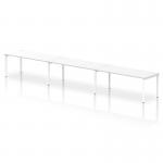 This photograph captures a modern and sleek design - Dynamic Bench Desking Impulse Bench Single Row 3 Person 1800 White Frame Office Bench Desk. The clean lines of the white frame are enhanced by the crisp white desktop, adding a touch of sophistication to any office space.