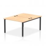 This picture shows a sleek and modern Dynamic Bench Desking Impulse Bench, designed for 2 people. The desk features a black frame with a 1200 mm width, paired with a maple finish top. It is perfect for any office setting, offering ample workspace and a contemporary aesthetic.