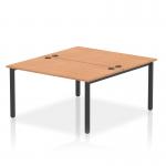 This image features a dynamic bench desking system with two person seating. The black frame adds a sleek touch to the office bench desk, while the oak surface brings a natural element. Perfect for collaborative workspaces or modern offices.
