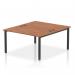 The photograph captures a modern and innovative office setup with a dynamic bench desking system. The Impulse Bench B2B, designed for 2 people, features a sleek black frame and a timeless walnut office bench desk.
