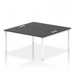 This photo captures a sleek and modern office set-up with two dynamic bench desking units, featuring a white frame and a black desktop. The clean lines and simple design create a professional and efficient workspace for two people.