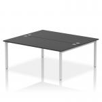 This photo shows a sleek, modern office setup featuring two person bench desks with silver frames and black surfaces. The dynamic bench desking promotes collaboration and productivity in the workplace.