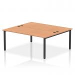 This image shows a sleek and modern dynamic bench desking setup with a black frame and a beautiful oak desktop. The bench is designed for 2 people with 1800mm width, making it perfect for offices and professional workspaces.
