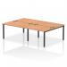 This image features a dynamic bench desking setup with four workstations, each with a black frame and oak desktop. The modern design of the impulse bench is perfect for any office space.