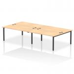 This photo features a dynamic bench desking setup with an Impulse Bench B2B for 4 people. The black frame adds a modern touch to the 1600 bench desk, which is made of sleek maple. Perfect for any office space.