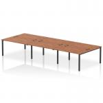 This photograph captures the dynamic look of the Impulse Bench B2B 6 Person Desk, featuring a sleek black frame and beautiful walnut finish. The spacious design provides ample workspace for a productive office environment.