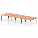 This picture features a sleek and modern dynamic bench desking setup, specifically the Impulse Bench B2B model. It can accommodate 6 people and has a black frame and a beech-colored desktop. Perfect for any professional office setting.