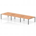 In the image, there is a modern and sleek 6-person dynamic bench desking system with an oak desktop and a black frame. The desks are arranged in a linear configuration, creating a collaborative workspace. The open design allows for easy communication and flexibility in layout.