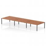 This photograph captures a sleek and modern Dynamic Bench Desking Impulse Bench B2B, designed for 6 people and featuring a sophisticated 1800 Black Frame. The spacious, contemporary walnut office bench desk is both stylish and practical.