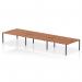 This photograph captures a sleek and modern Dynamic Bench Desking Impulse Bench B2B, designed for 6 people and featuring a sophisticated 1800 Black Frame. The spacious, contemporary walnut office bench desk is both stylish and practical.