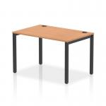 The image shows a sleek, modern office space with a row of single, black-framed bench desks. The desks are made of oak and have a dynamic, versatile design, perfect for a collaborative work environment.