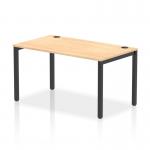 The picture shows a modern and sleek Dynamic Bench Desking Impulse Bench, with a single row and a length of 1400. The black frame adds a touch of sophistication, while the office bench desk is made of a beautiful maple wood. This IB00606 piece is perfect for any contemporary workspace.
