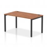 This photograph features a sleek and modern office bench desk with a 1400mm single row design. The frame is black and the top is made of walnut, creating a striking contrast. The dynamic design of this desk makes it perfect for a contemporary office space.