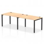 The picture features a sleek and functional Dynamic Bench Desking Impulse Bench, with a single row of two desks. The 1200 black frame adds a modern touch, while the office bench desk is made of maple for a warm and inviting feel.