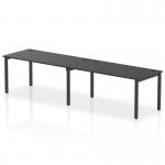 The image shows a sleek and modern office space, with a dynamic bench desk featuring a single row for 2 people. The desk has a black frame and is accompanied by a matching black office bench desk. This setup, known as Impulse Bench, is perfect for a collaborative and efficient work environment.