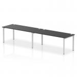 This photo features a sleek and modern dynamic bench desking system, with a single row of two person desks. The silver frame adds a touch of sophistication, while the black desk perfectly complements the overall design. Ideal for any office space looking for a contemporary and functional work area.