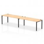 This photo features a sleek and modern bench desk, specifically Impulse Bench Single Row for 2 people. With a black frame and maple desk, it provides a dynamic and functional workspace for any office.