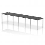 The photo captures a sleek and modern office setting with a single row of three black bench desks. The silver frames add a touch of elegance to the dynamic and spacious design of the impulse bench, perfect for a collaborative and efficient work environment.
