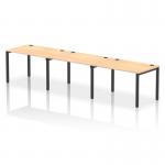 This picture shows a modern and versatile bench desking setup, with a sleek black frame and warm maple desk surface. The single row design can comfortably seat up to 3 people, making it a practical choice for any office.