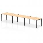 The picture shows a modern dynamic bench desking setup, with a sleek black-framed impulse bench for three people in a single row. The desk is made of maple wood, lending an elegant touch to any office space.