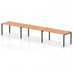 The image shows a sleek and stylish single row bench desk featuring three workstations. The desk has a black frame and is made of oak wood, exuding a modern and dynamic vibe. It is perfect for office environments and offers a spacious and efficient working space.