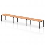 This image showcases a sleek and modern 3-person bench desk from the Dynamic Bench Desking Impulse collection. With a sturdy black frame and a stylish oak finish on the desktop, this bench adds a touch of sophistication to any office space.