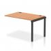 This image features a modern and sleek Dynamic Bench Desk Add On Unit with Impulse Bench Single Row Extension Kit, measuring 1200 in length. The frame is black, contrasting beautifully with the oak desktop. Perfect for a contemporary office space.