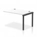 A sleek and modern office setting with a row of bench desk add-on units in black frame, extending the length to 1200cm. The white desk surfaces are perfect for collaboration and productivity.