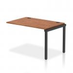 In this photograph, we see a modern and functional bench desk set up. The dynamic bench desk add on units add versatility and the black frame adds a sleek touch. The walnut office bench desk looks stylish and provides ample workspace. This single row extension kit is perfect for any office.