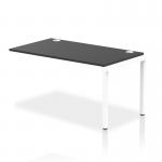 This photograph captures a row of sleek, modern white frame bench desk add on units, seamlessly connected to create a dynamic workspace. The black elements add contrast and sophistication to the overall design. The clean lines and open layout invite focus and productivity.