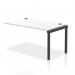 A sleek, modern office setup. The Dynamic Bench Desk Add On Units feature a sturdy black frame and white bench desk, adding extra space for single row extension. Perfect for a professional and functional workspace.