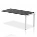 The photo shows a sleek silver-framed office bench desk with a row of black add-on units, creating a dynamic and versatile workspace. The desk is spacious and modern, perfect for any professional setting.
