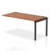This photograph shows a sleek and contemporary office workspace with dynamic bench desk add on units, an impulse bench single row extension kit, a black frame, and a walnut finish. It exudes a professional and modern aesthetic, perfect for any dynamic and productive office environment.