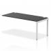 The photo shows a sleek and modern office bench desk with add on units, featuring a silver frame and black desktop. The single row extension kit adds versatility to this dynamic bench, perfect for any workspace.