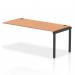 In this image, we see a row of sleek black bench desks, with a single extension kit and an oak tabletop. The desks dynamic design and sturdy frame make them a functional addition to any modern office space.