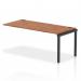 A sleek and modern office setup, this photograph features a dynamic bench desk with add-on units and an impulse bench single row extender kit. The black frame and walnut desk add a stylish touch to the workspace.