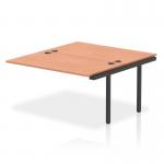The picture shows a modern dynamic bench desk add on unit, specifically the Impulse Bench B2B Extended Kit 1400 with a sleek black frame. The office bench desk has a durable beech surface, creating a professional and functional workspace. This add on unit is perfect for any contemporary office setting.