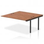 The photograph showcases a sleek and modern dynamic bench desk, complete with add on units and impulse bench B2B extension kit. The black frame and elegant walnut wood make for a sophisticated and professional look, perfect for any office space.