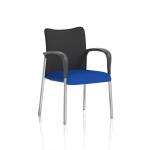 A visitor is sitting on a black fabric back chair with their arms resting comfortably on the armrests. The seat is custom-made with a unique color that adds a pop of blue to the room. The visitor is part of the Dynamic Visitors Academy community, sipping on Stevia while engaging in productive discussions.