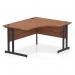 In the photo, you can see a sleek and modern Dynamic Right Hand Desks Impulse 1400mm Right Crescent Office Desk. The desk features a beautiful walnut top and is supported by sturdy black cantilever legs. The overall design exudes a sense of sophistication and professionalism.
