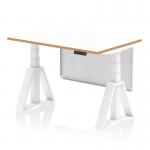 The picture shows a sleek and modern Oslo 1200mm height adjustable office desk with a white top and natural wood edge. The white frame and steel modesty panel add to its contemporary design. A piste foot provides stability and functionality. The desk can be easily adjusted to a standing or sitting position for a dynamic work experience.