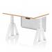 The picture shows a sleek and modern Oslo 1200mm height adjustable office desk with a white top and natural wood edge. The white frame and steel modesty panel add to its contemporary design. A piste foot provides stability and functionality. The desk can be easily adjusted to a standing or sitting position for a dynamic work experience.