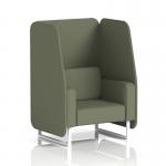 In this image, we see a sleek and modern dynamic booth with white legs. The booth features a 1 seater open design, upholstered in Main Line Flax fabric. Monument panels add a touch of sophistication to the piece, and a matching sofa can be seen in the background. Perfect for a contemporary office or lounge setting.